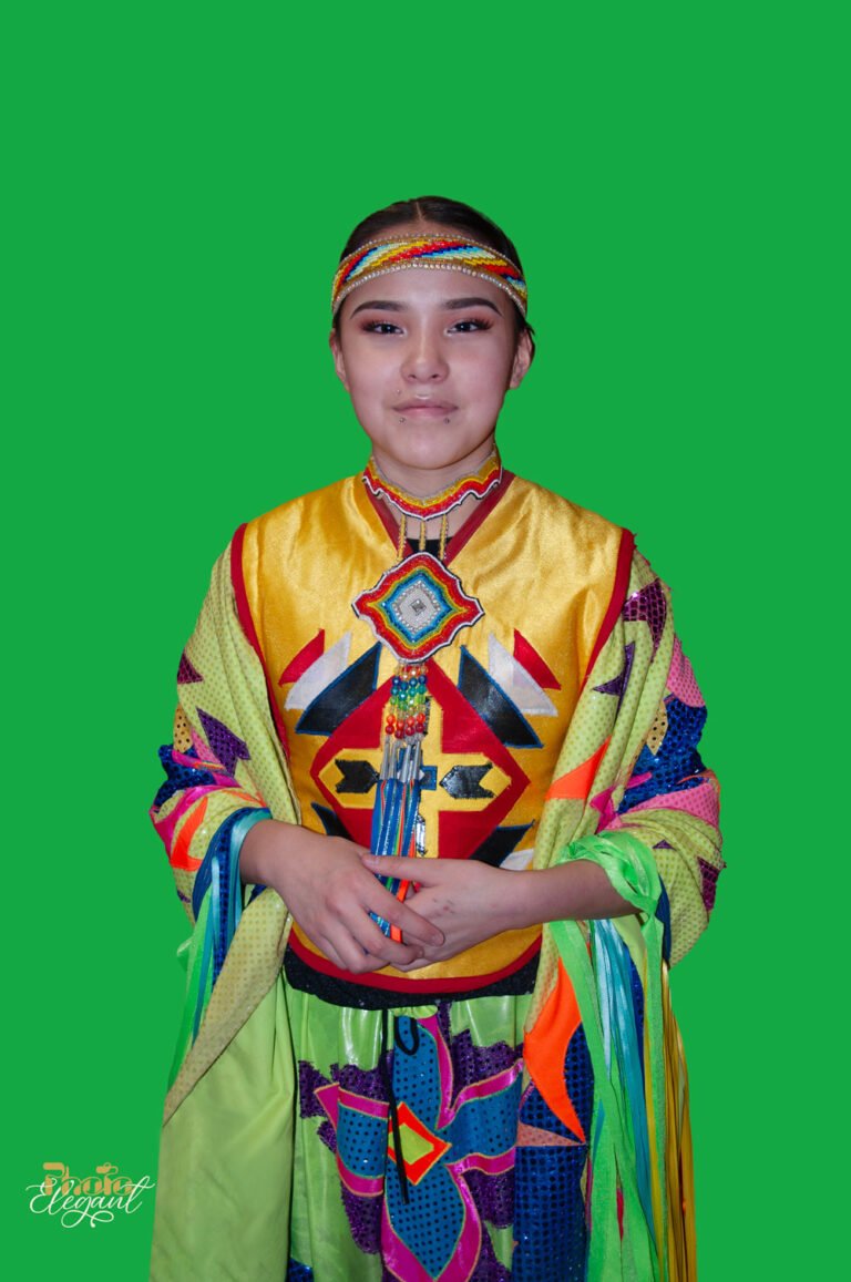 A beautiful young woman hides her face with her arm, revealing only her striking eyes and intense gaze.